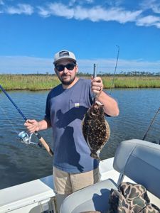 Angler with a southern flounder caught in NC