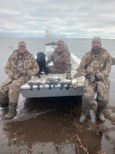 Three people enjoying a great fishing and hunting trip in Manteo