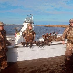 Two people enjoy fishing and hunting in Manteo