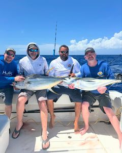 Group of four people fishing together in West Bay