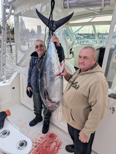 Two anglers reeling in a great catch on the water in New Jersey
