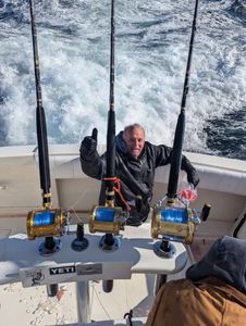 Person enjoying fishing cruises in Forked River