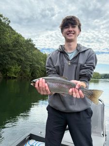 Angler with a rainbow trout in Branson, Missouri