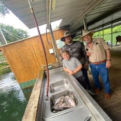 Two people fishing in the scenic town of Branson