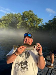 Angler with rainbow trout fish in Branson