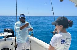 Three people enjoying a fishing tour in Marathon