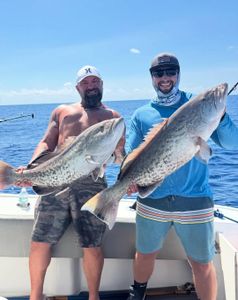 Two anglers with big fish caught at Holmes Beach
