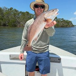 A fisherman reels in a catch on the coast of Florida