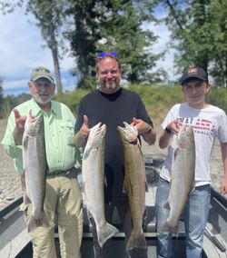 Three anglers with four rainbow trout fish in Washington state