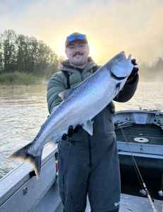 A fisherman holding a 27-inch fish in WA