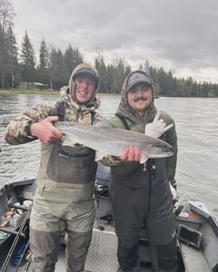 Successful anglers with a large rainbow trout in WA