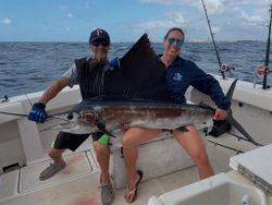 Two people fishing for an Atlantic Sailfish in West Palm Beach