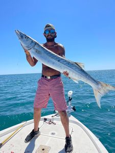 A fisherman holding a 44-inch fish in NC