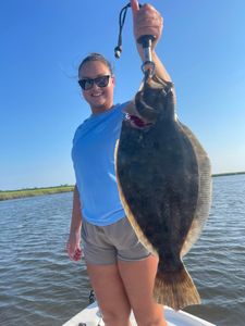 A Pacific Halibut fish caught during a cruises and fishing adventure at Sunset Beach