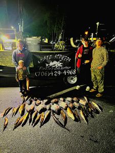 Four people enjoying a fishing trip at Lake City