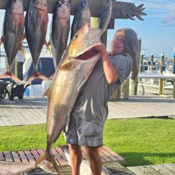 Angler holding three king mackerel in Gulf Shores