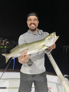 A anglers holding a spotted weakfish catch in Florida