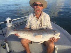 A person holding a big redfish in Port Aransas