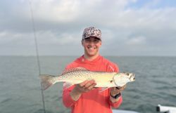 A fisherman catching a spotted weakfish in Port Aransas