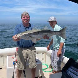 Striped bass caught by two people fishing in MA