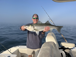 Big Striped Bass reeled in during a clear day in Yarmouth!