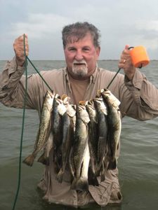 A person fishing in Corpus Christi with 3 fish