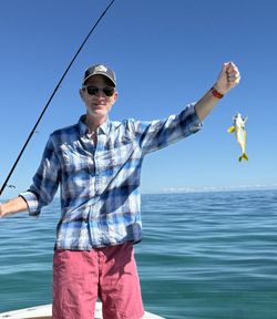 Angler holding freshly caught fish on boat in Islamorada FL waters