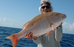 A proud angler with a magnificent mutton snapper catch in FL