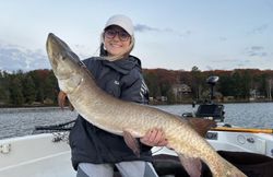 Angler holding muskellunge fish caught while fishing in WI