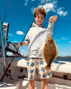 Angler catching a southern flounder fish in New York City