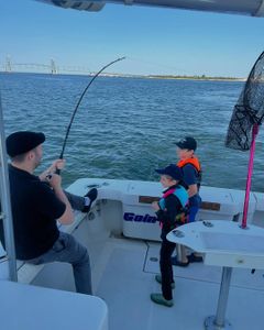 Three people enjoying a fishing trip in NY