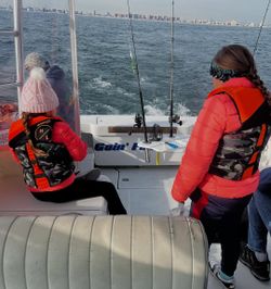 Anglers fishing in the iconic New York City skyline