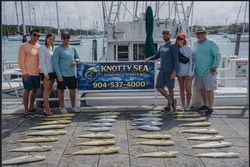 Fishing charter catch displayed on dock with charter boat in Port Orange FL marina