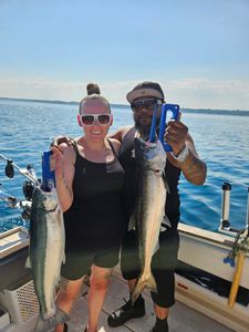 Two large salmon caught during fishing charter in Port Washington WI, displaying successful Chinook salmon fishing results