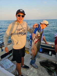 Three people enjoying a fishing cruise in Port Washington
