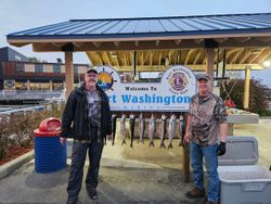 Fishing charter display showing multiple caught fish hanging at Port Washington WI marina with welcome sign