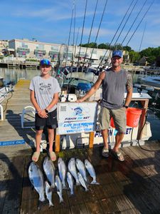 Charter fishing trip catch of Chinook and Coho salmon displayed on dock in Port Washington WI