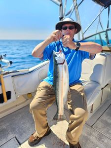 Fresh caught salmon held up on fishing charter boat in Port Washington WI waters