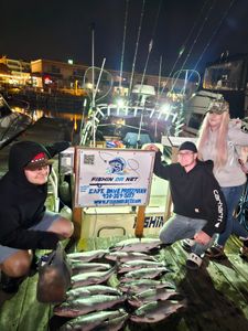 Two anglers reeling in their catch during a fishing cruise in Wisconsin