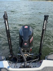 Mercury outboard motor mounted on fishing boat transom with fishing rods in holders on water in Zavalla TX