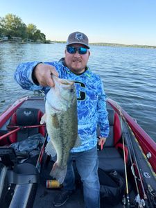 Angler holding caught bass on fishing boat in North Tonawanda NY lake