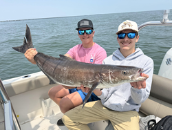 Reeling in the best catch on the back deck under partly cloudy skies!