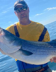 Angler holding a 25-inch fish in Scituate