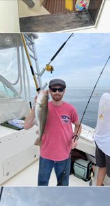 Angler fishing in Scituate, with a 18-inch catch