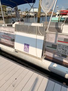 Wheelchair accessible fishing boat docked at marina in New Port Richey FL with accessibility ramp and equipment