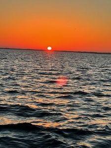Sunset over ocean waters in New Port Richey FL with sun reflecting on waves