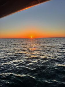 Sunset view over ocean waters from boat deck in New Port Richey FL
