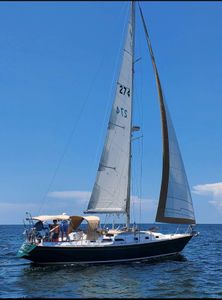 Sailboat with white sails cruising on blue ocean water in New Port Richey FL