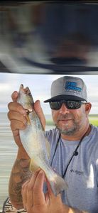 One fisherman holding a 13-inch fish in Ludowici