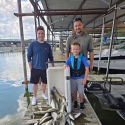 Three people enjoying fishing trip in TX